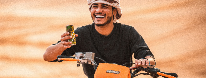 An Arab driving a quad bike in the UAE desert
